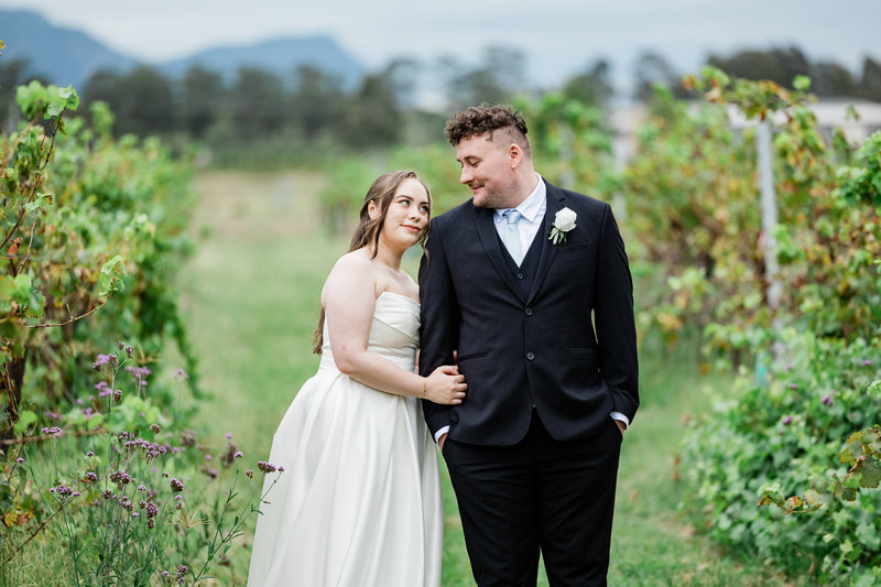 “Intimate Hunter Valley wedding photography – bride and groom smiling in vineyard”